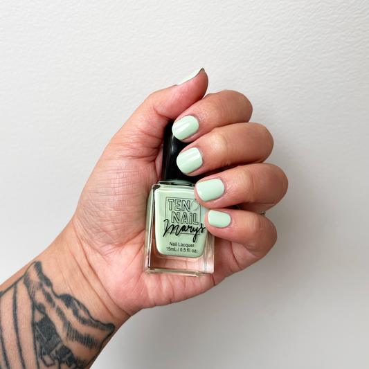 Water Hemlock painted on fingernails with tattooed arm